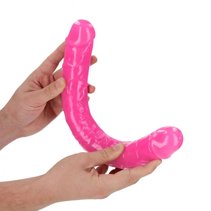 REALROCK 38 cm Glow in the Dark Double Dildo in Pink, flexed between two hands to show its bend