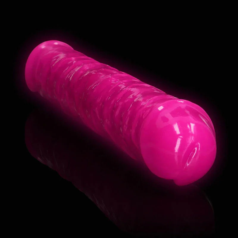 REALROCK 38 cm Glow in the Dark Double Dildo in Pink, glowing against a black background