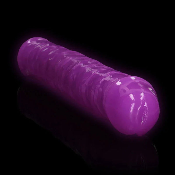 REALROCK 38 cm Glow in the Dark Double Dildo in Purple, glowing against a black background