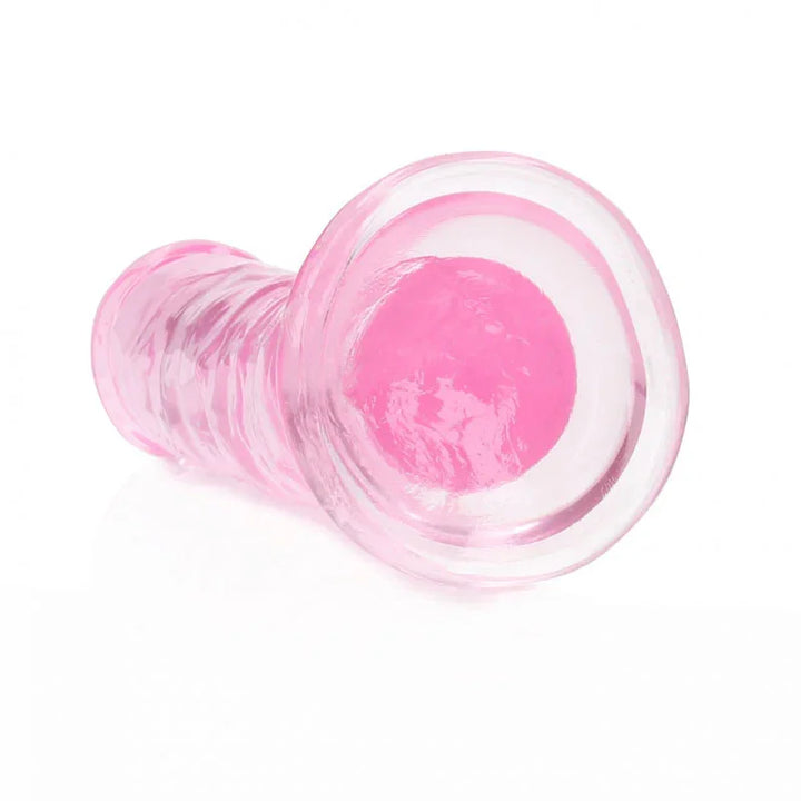 REALROCK 15.5 cm Straight Dildo in Pink, lying down with the suction base facing the camera