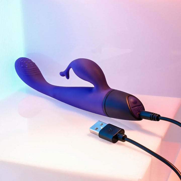 Plum Passion with its USB charging cable plugged into the black base