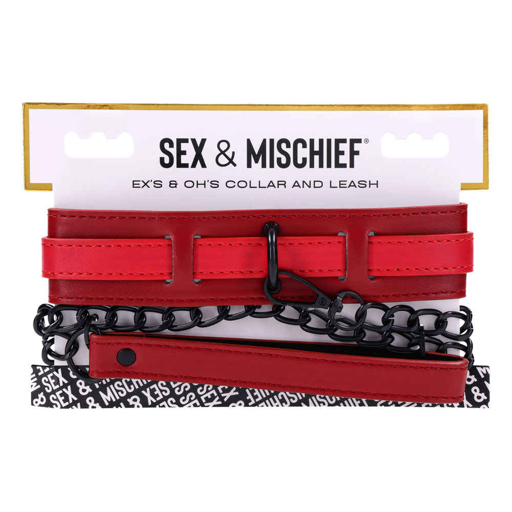The S&M Exs & Ohs Collar and Leash - Red Neck Restraint from Sex & Mischief features a red faux leather collar with multiple horizontal straps, a sturdy matte black chain, and a sleek clasp. The packaging is white with black text and a stylish black-and-white pattern at the bottom.