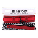 The S&M Exs & Ohs Collar and Leash - Red Neck Restraint from Sex & Mischief features a red faux leather collar with multiple horizontal straps, a sturdy matte black chain, and a sleek clasp. The packaging is white with black text and a stylish black-and-white pattern at the bottom.