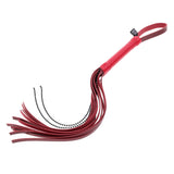 The S&M Exs & Ohs Crystal Flogger, a red faux leather flogger whip, features a grip-friendly handle and wrist strap. Its multiple tails have black bead tips, perfect for impact play or role-playing. Displayed against a white backdrop, it highlights the floggers vibrant color and intricate details.