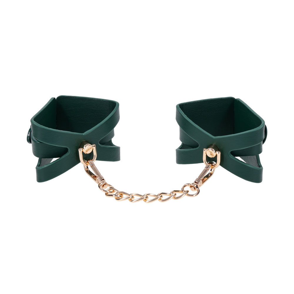Pair of green cutout cuffs standing upright, joined by the gold chain