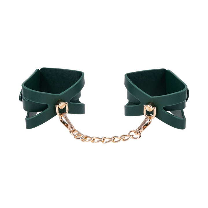 Pair of green cutout cuffs standing upright, joined by the gold chain