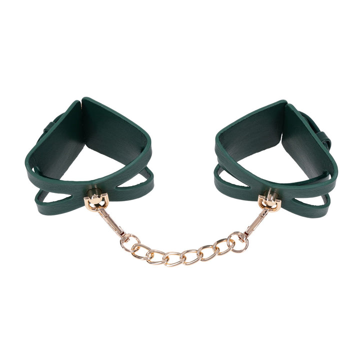 Indica cutout cuffs opened wide with the gold chain stretched between