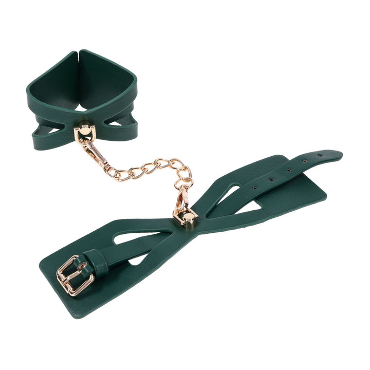 One Indica cuff shaped into a ring beside the other laid flat, chain between