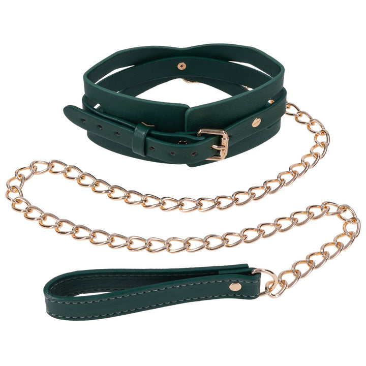 Green Indica collar coiled with the gold chain leash and green handle beside it