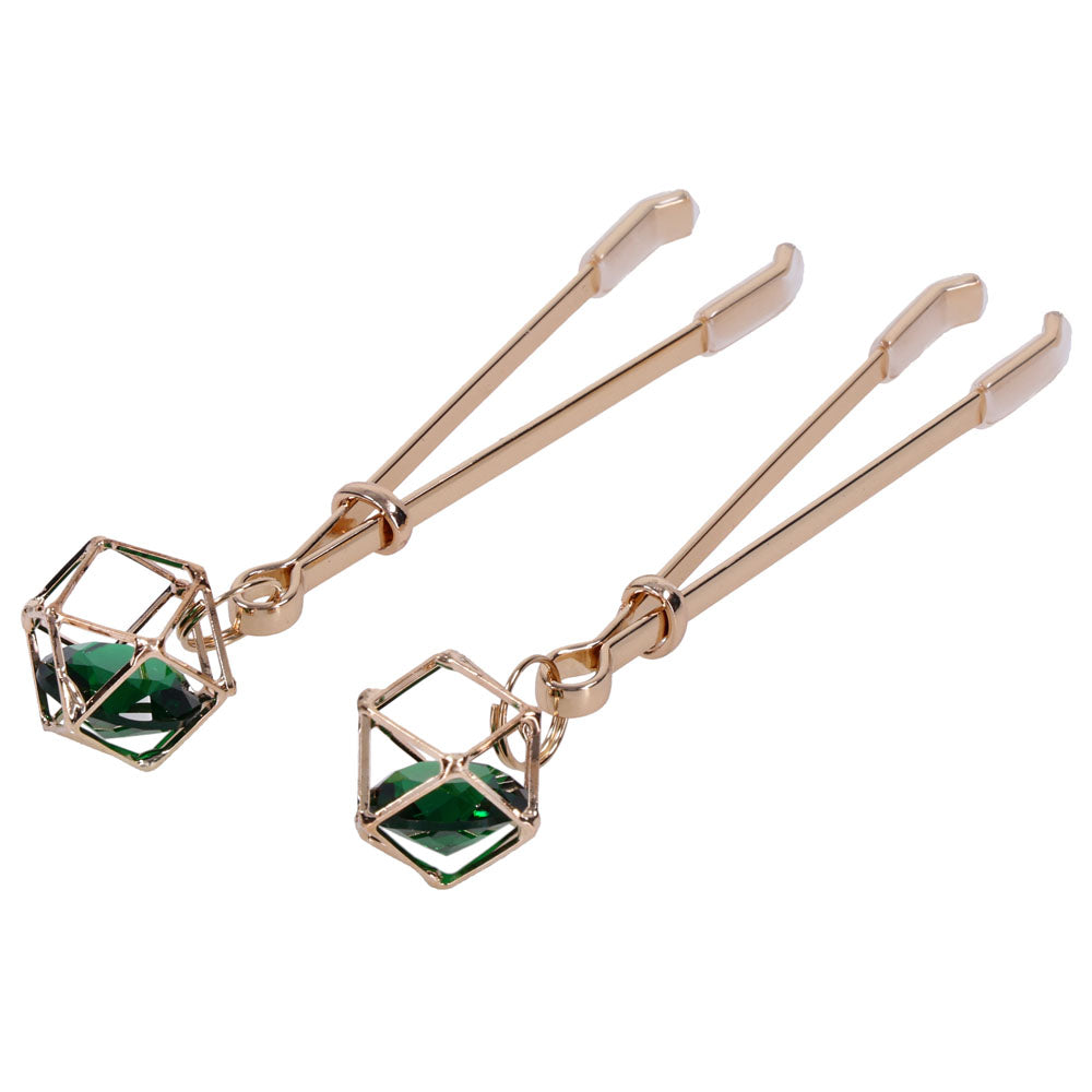 Close-up of the caged green crystal charms on the Indica nipple clips