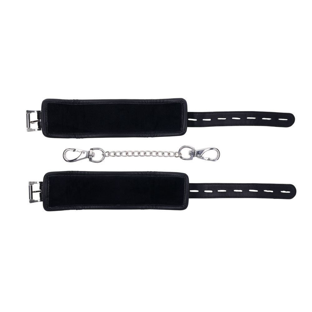 Two black EDGE Handcuffs with silver buckles and adjustable closures, connected by a short silver chain with clips, offer secure yet comfortable restraint. Laid against a white background.