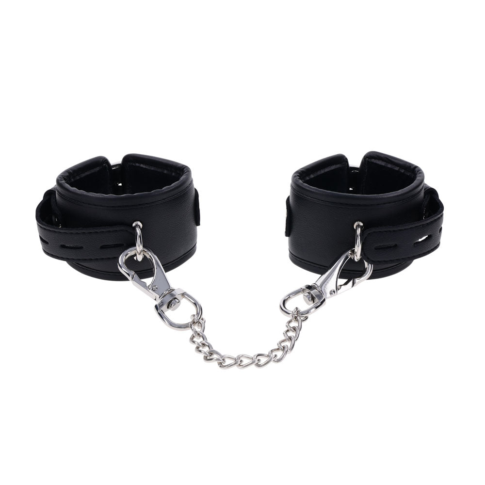 The EDGE Handcuffs - Black Restraints feature a sleek black leather design, a silver metal chain with clips, and adjustable buckle closures for secure restraint. The smooth leather and shiny metal enhance their allure.