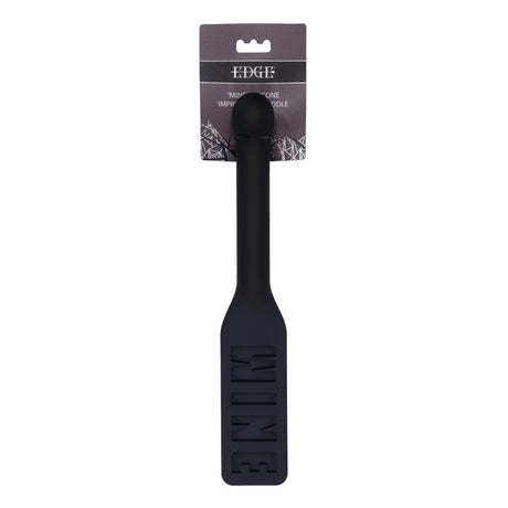 The EDGE MINE Silicone Paddle - Black Spanking Paddle is embossed with WINE on the blade, features a long insertable handle for efficient cooking, and is packaged on a dark background with white text for a sleek, modern design.