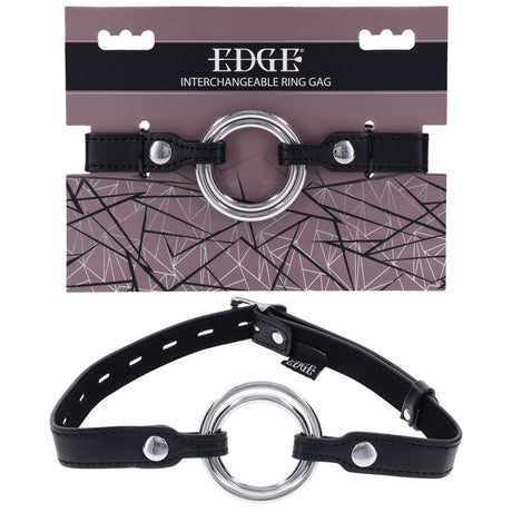 The EDGE Interchangeable Ring Gag in black leather, featuring a large stainless steel ring and adjustable straps with metal buckles for secure fastening, is showcased. The EDGE packaging displays a geometric pattern against a muted purple background.