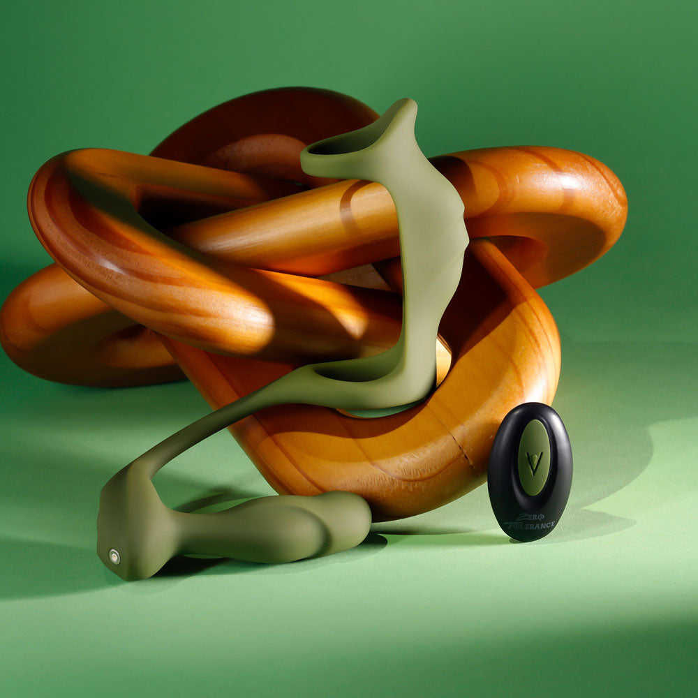 Green Prostate Power Pack draped over wooden rings with its black remote