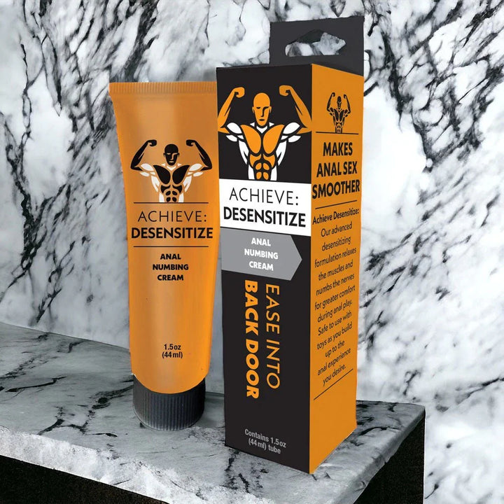 Achieve Desensitize tube and carton staged on a white marble ledge