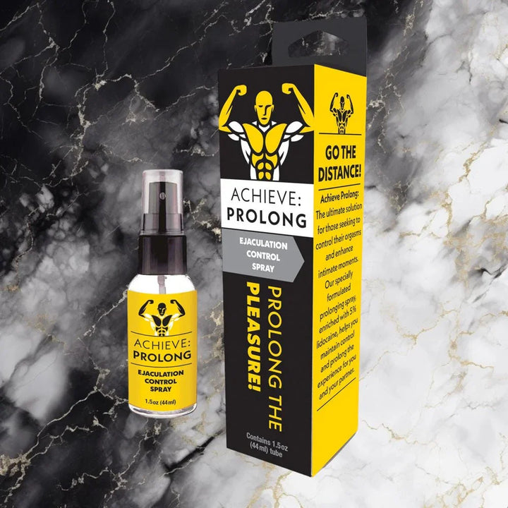 Achieve Prolong spray and carton on a black and gold marble surface