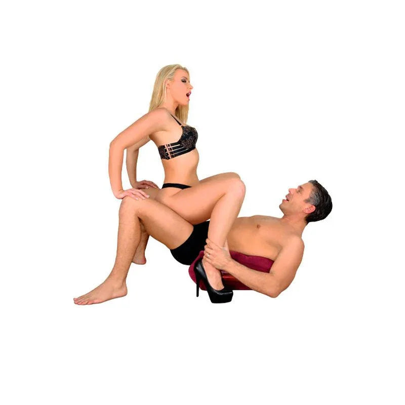 Couples in intimate pose, woman in black lingerie and heels, man in red towel, demonstrating use of sex toy.