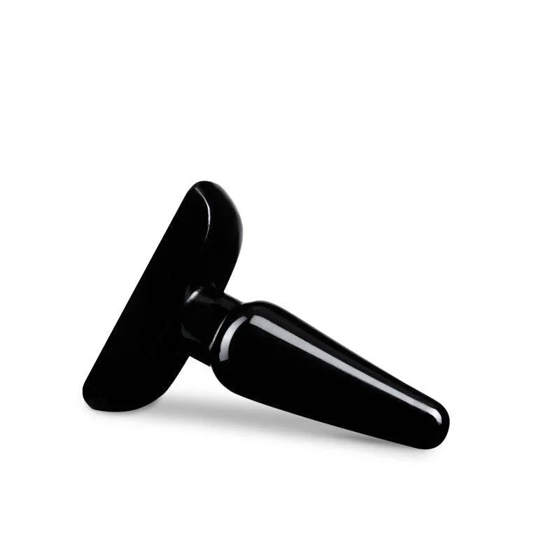 Small black Basic Anal Plug lying on its side, flat base to the left