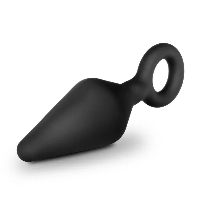 Small black Loop Plug lying at an angle with the tapered tip toward the lower left