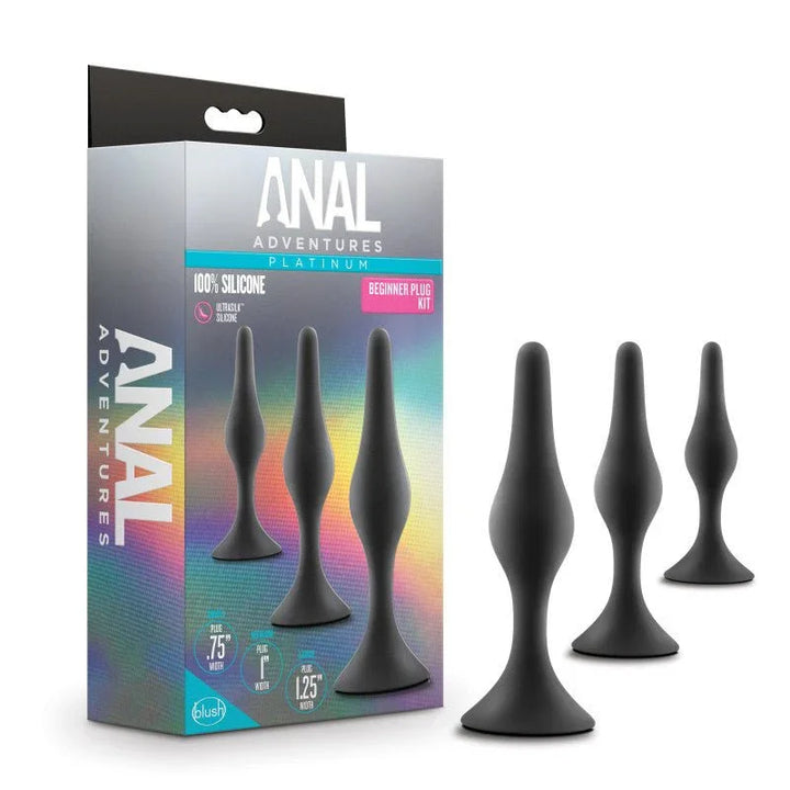 Anal Adventures Platinum Beginner Plug Kit, three black plugs beside the rainbow box