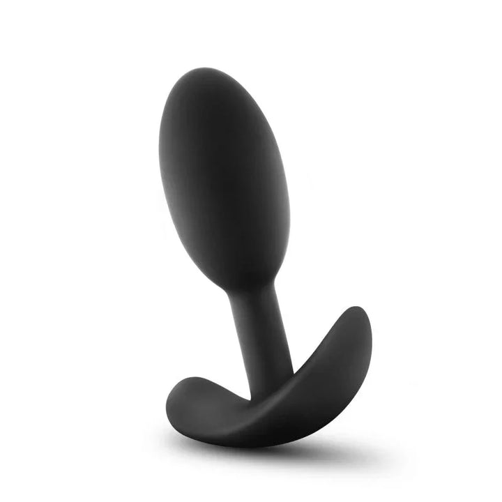 Small black Vibra Slim Plug standing at an angle, satin silicone finish