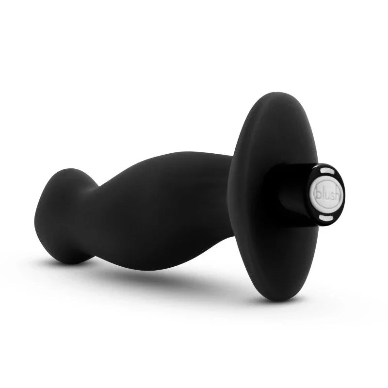 Prostate massager 02 lying down with the blush-branded base disc facing the camera