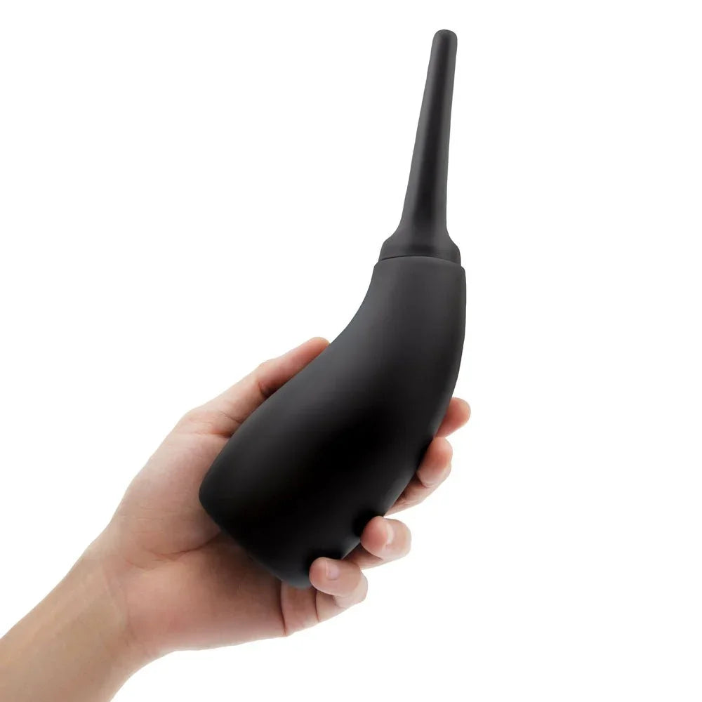 A hand gripping the black AquaClean Contoured Ergo bulb, nozzle angled upward