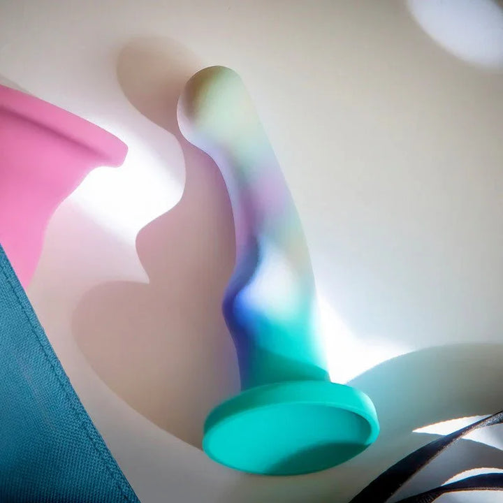 Opal Dreams dildo standing on a softly lit surface, opalescent shaft catching the light