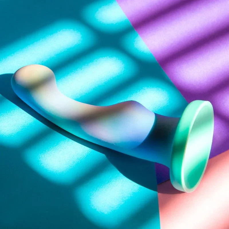 Opal Dreams dildo lit by blue and purple neon bars, glowing aqua base