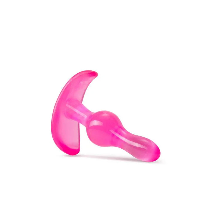 Pink curvy anal plug lying on its side with the tapered tip to the right