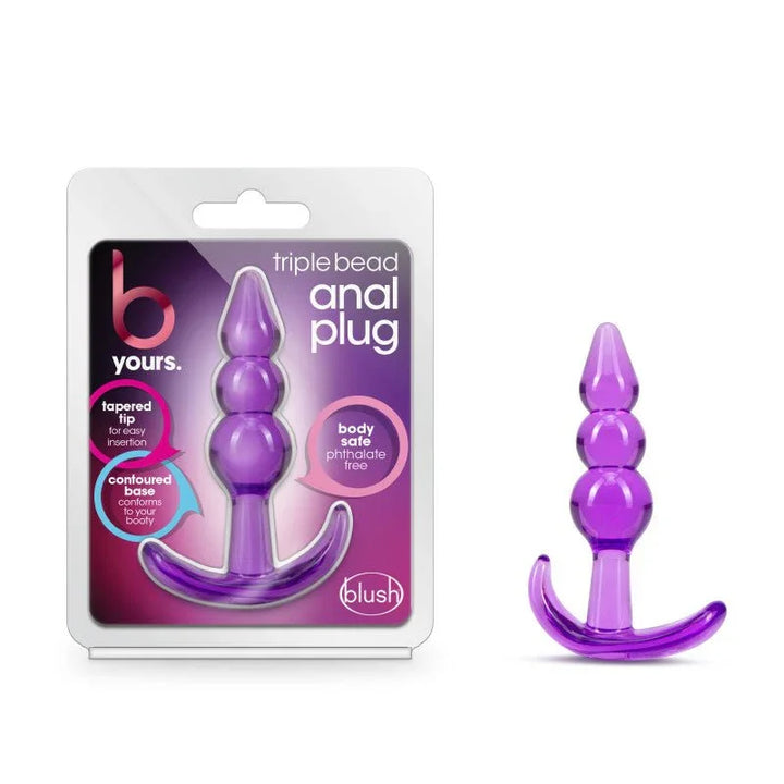 B Yours Triple Bead Anal Plug in translucent purple beside its blister pack