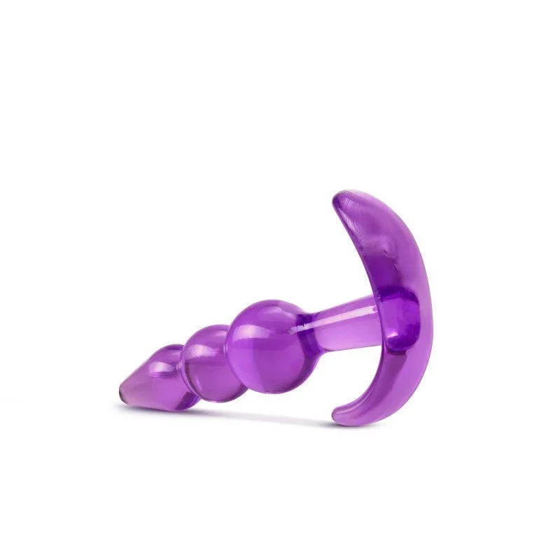 Purple triple bead plug lying down with the curved base facing the camera