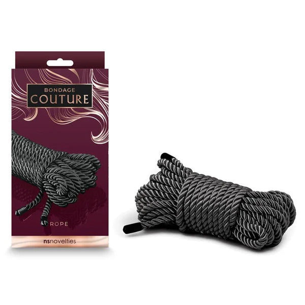 Bondage Couture bondage rope in Black, 7.6 m coiled with bound ends, beside the burgundy box