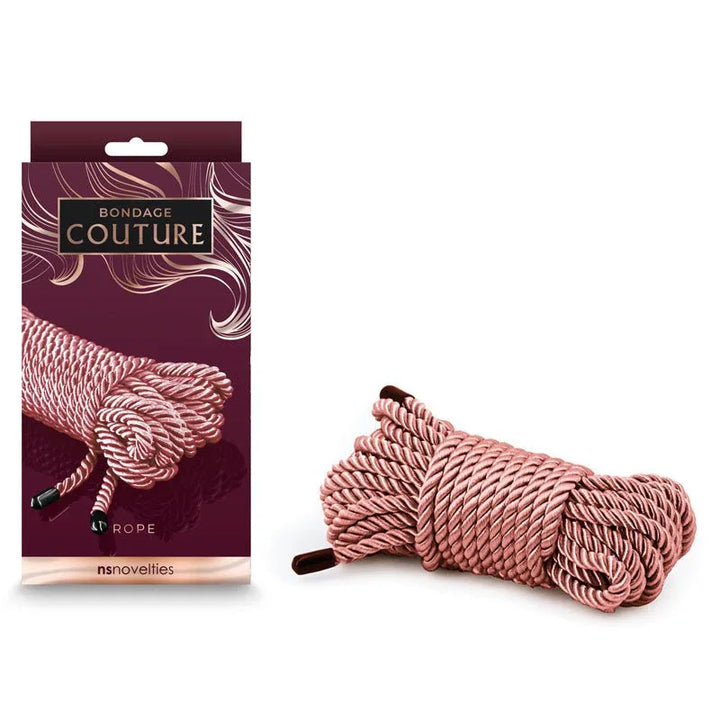 Bondage Couture rope in Rose Gold, 7.6 m coiled with dark tips, beside its burgundy box
