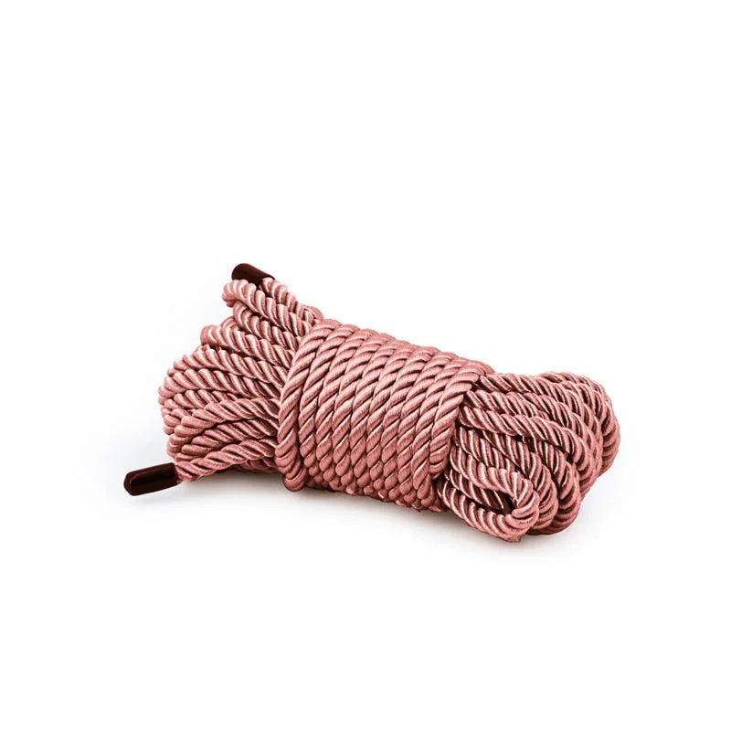 Bondage Couture rope in Rose Gold, coiled hank on white showing the twisted satin strands