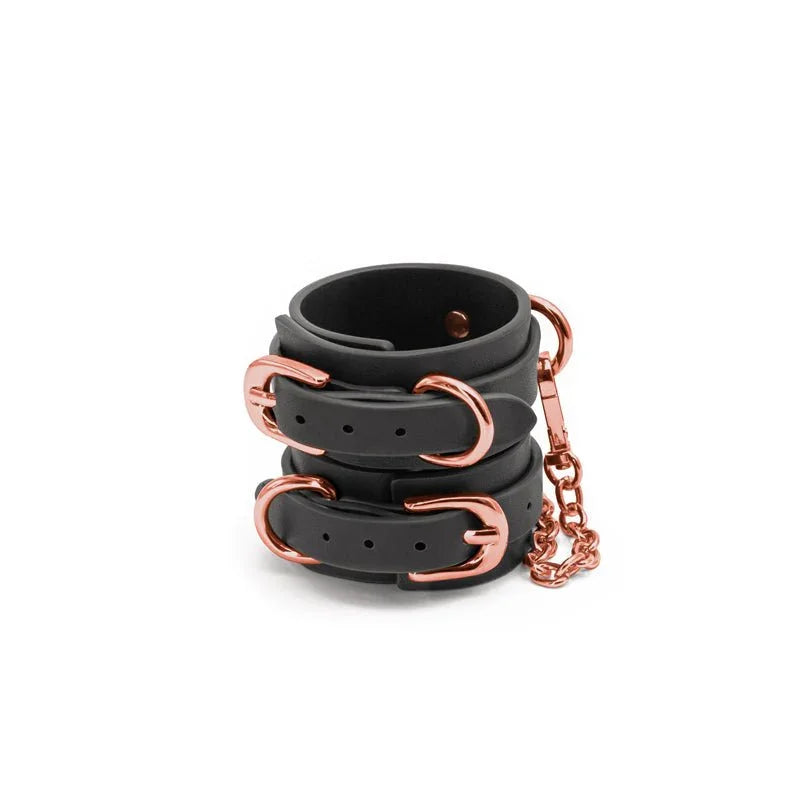Bondage Couture wrist cuffs in Black, pair stacked showing the connecting chain