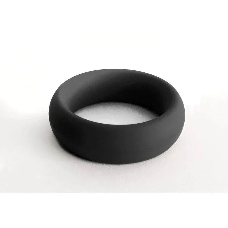 Black silicone cock ring, smooth matte finish, flexible band for enhanced sensation.
