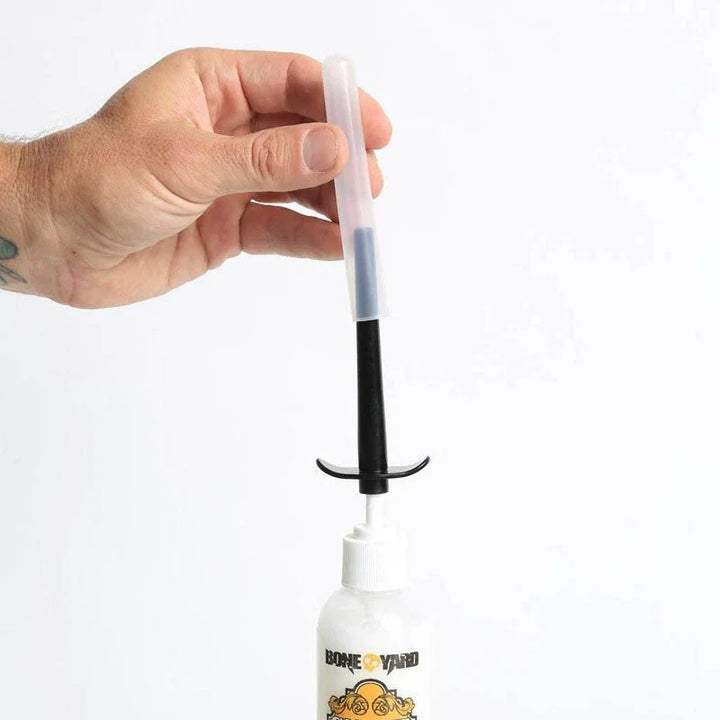 Boneyard Skwert injector assembled on a bottle, storage cap over the nozzle