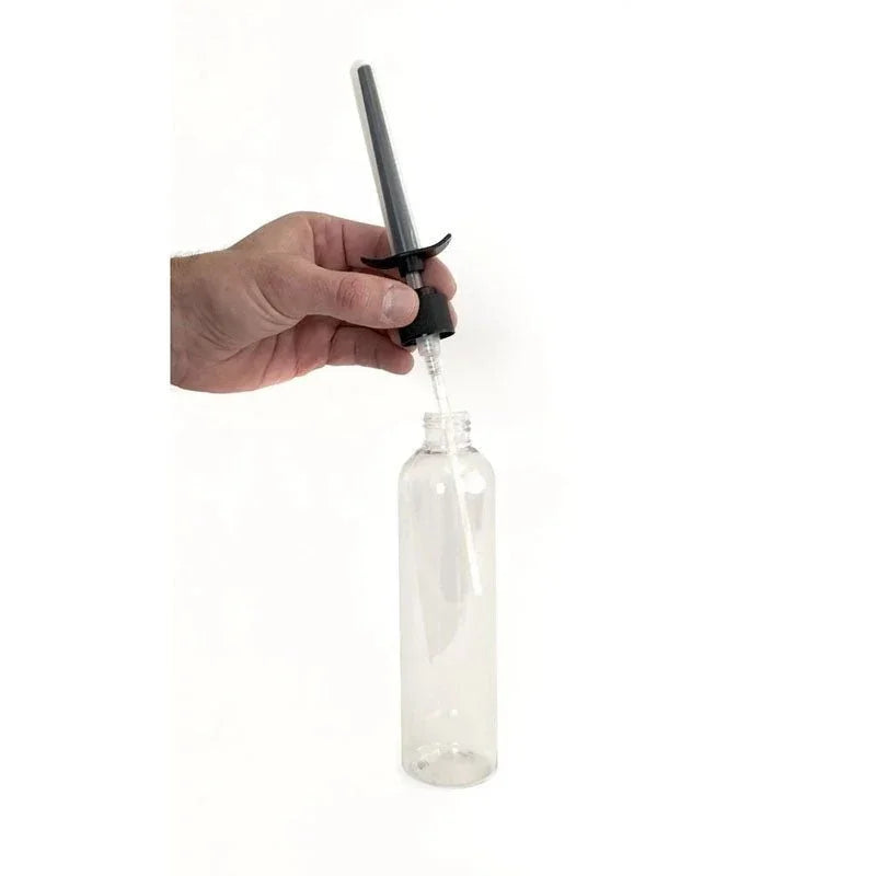 Boneyard Skwert nozzle being screwed onto a clear lube bottle