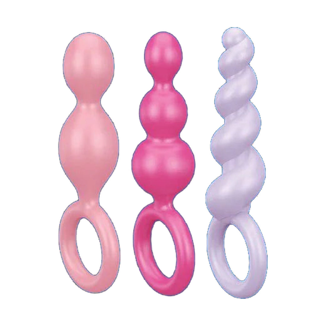 Satisfyer Booty Call butt plug set of 3 in pink, rose and lilac, showing the two-bead, three-bead and twisted shapes with pull rings