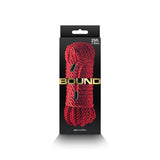 The Bound Rope - Red Bondage Rope, 7.6 meters long, is coiled and secured with black bands on a dark background. The BOUND brand name is prominently displayed across the center with nnovelties below, creating a striking contrast against the deep hues of the packaging.