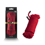 A red Bound polyester rope, 7.6 meters long with black capped ends, is coiled neatly next to its box, which features bold gold labeling and the ropes image.