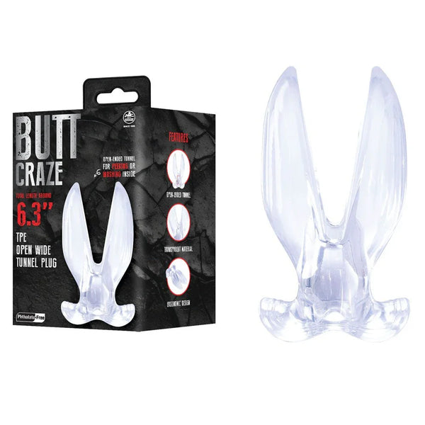 Butt Craze 16 cm gaping tunnel plug in Clear, tall open wings, beside its black retail box