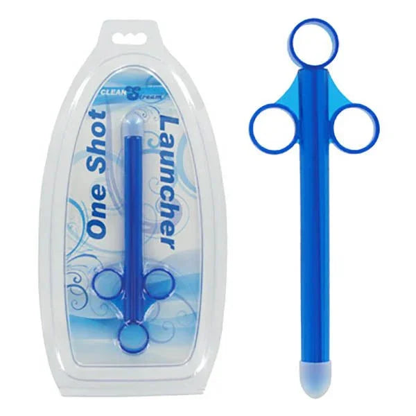 CleanStream One Shot Launcher in Blue, lube shooter beside its clamshell blister pack