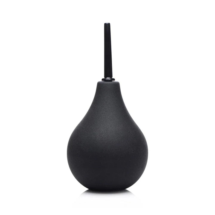 Black silicone enema bulb standing upright on white with the thin nozzle fitted