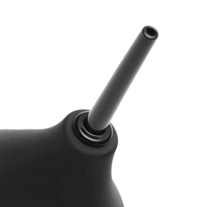 Close-up of the thin black nozzle screwed into the enema bulb's collar