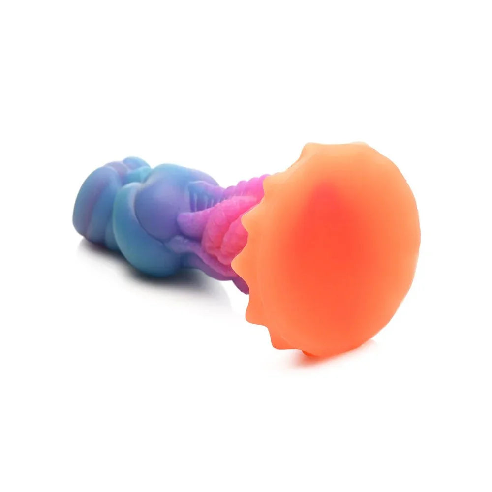 Aqua-Cock dildo lying with its orange coral suction base facing the camera