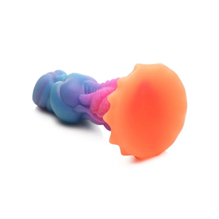 Aqua-Cock dildo lying with its orange coral suction base facing the camera