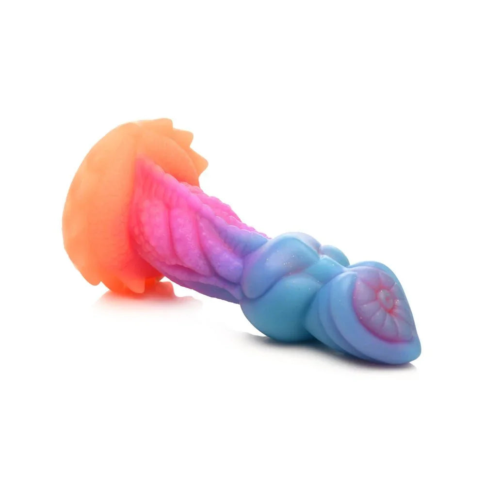 Aqua-Cock dildo lying flat on white, side profile from the orange base to the blue tip